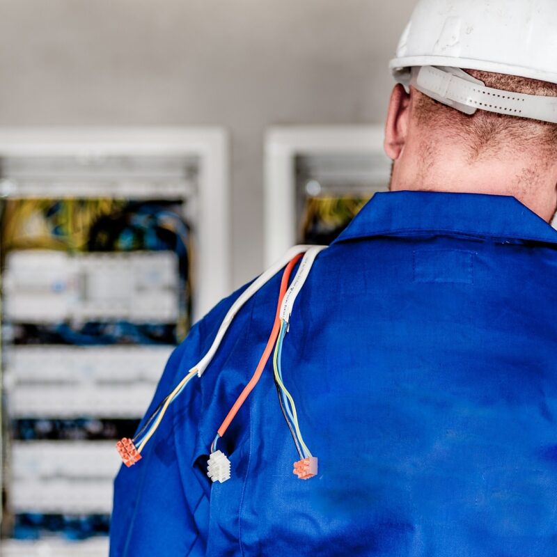 A picture showing a man in a blue shirt and hard hat, part of a blog post on choosing your electrician